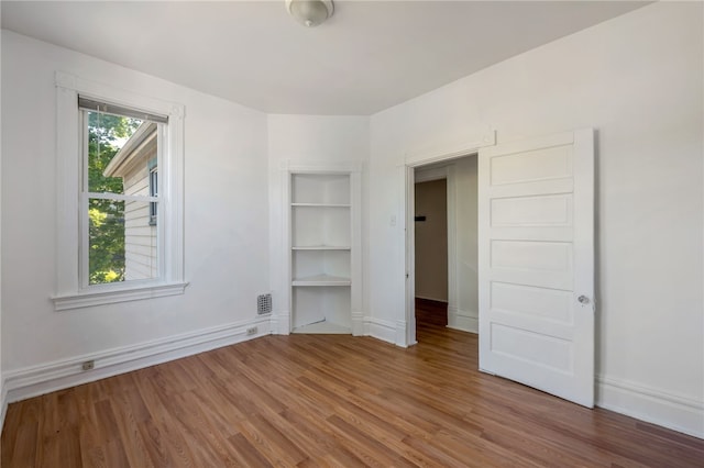 unfurnished bedroom with hardwood / wood-style floors