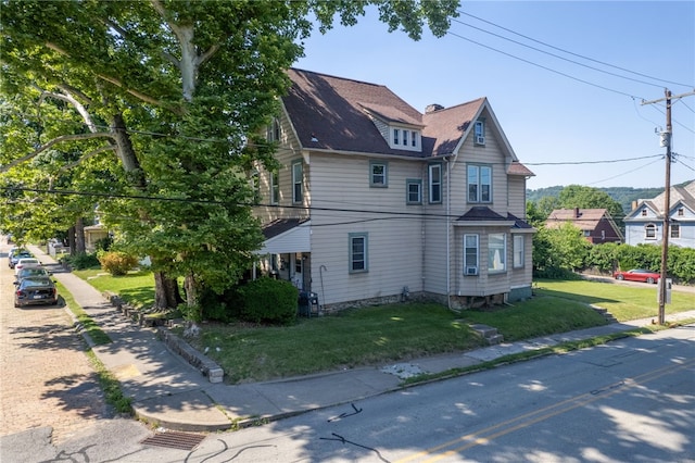 view of side of home with a yard