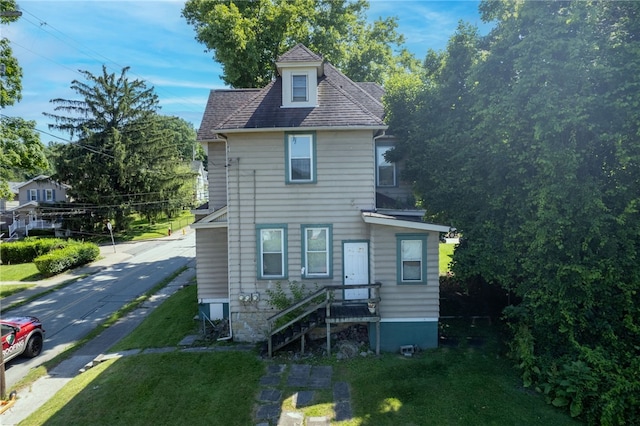 rear view of property with roof with shingles