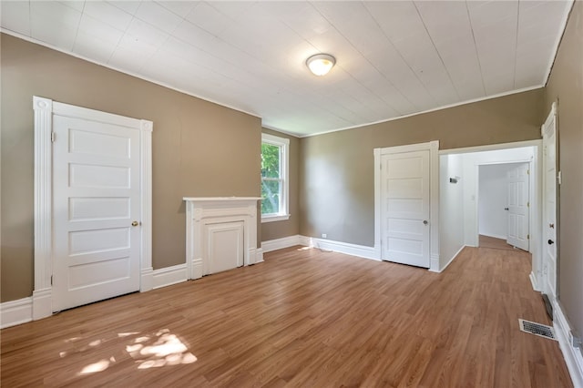 spare room featuring crown molding and wood-type flooring