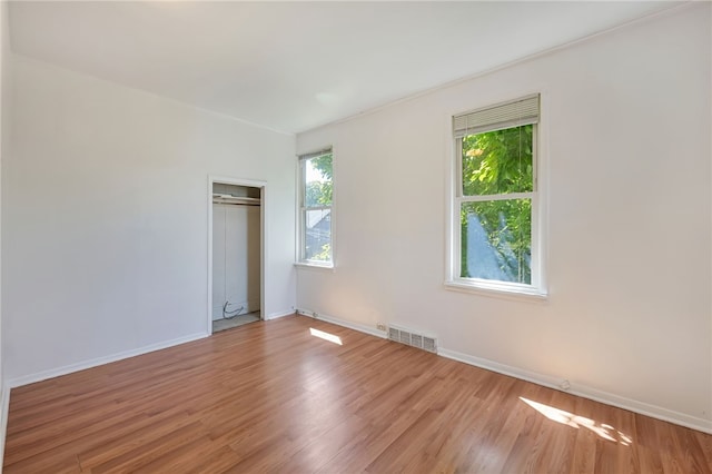 empty room with hardwood / wood-style floors