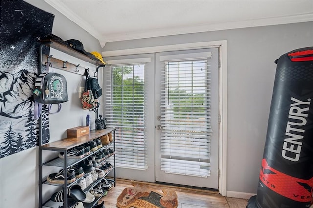 doorway with crown molding, french doors, and light hardwood / wood-style floors