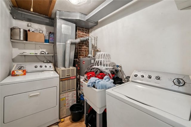 clothes washing area with separate washer and dryer and light hardwood / wood-style floors