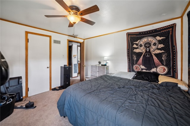 carpeted bedroom featuring ceiling fan and crown molding