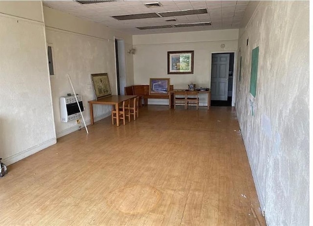 interior space with hardwood / wood-style floors and heating unit