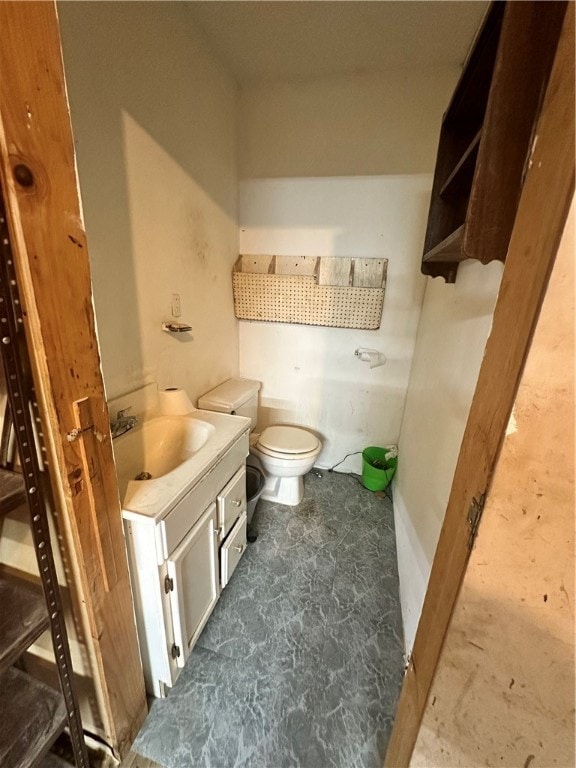 bathroom featuring tile floors, a tub, toilet, and vanity