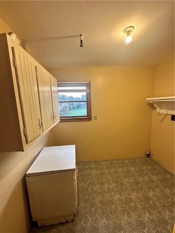 walk in closet with tile floors