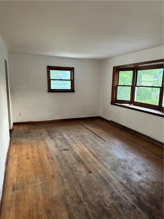 spare room featuring dark wood-type flooring