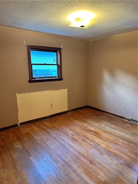 unfurnished room featuring hardwood / wood-style flooring