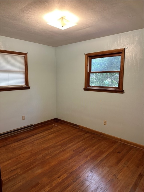 spare room with dark hardwood / wood-style floors