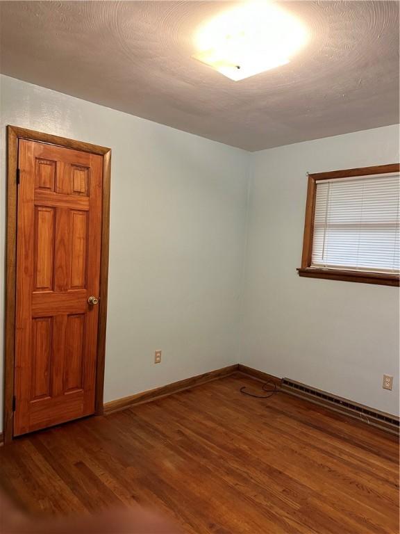 empty room featuring dark hardwood / wood-style floors