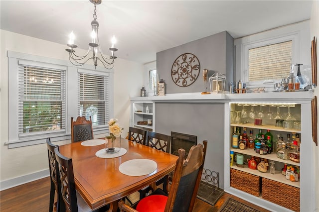 dining room featuring a chandelier and dark hardwood / wood-style floors