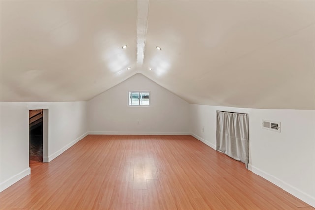 bonus room featuring lofted ceiling and light wood-type flooring