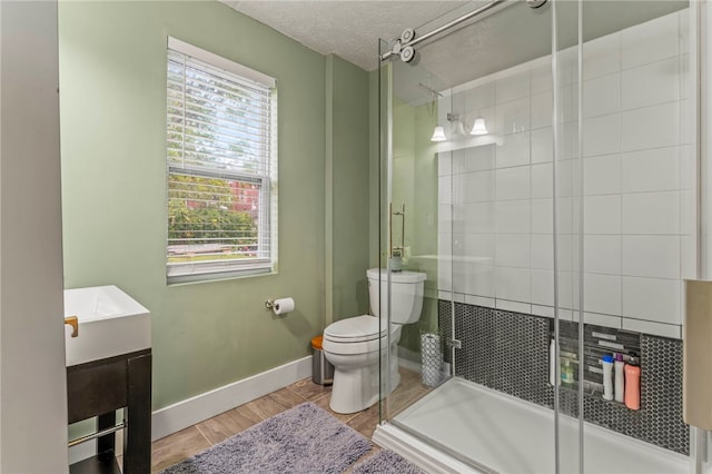 1534 Mcfarland Rd, Dormont, PA 15216 - bathroom with toilet, a stall shower, vanity, wood finished floors, and a textured ceiling