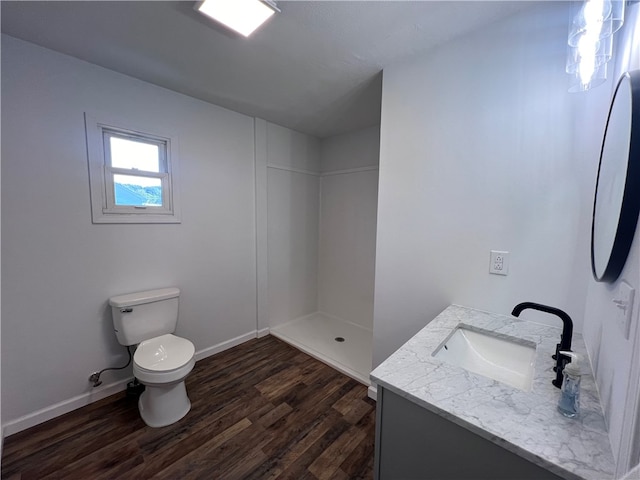 bathroom featuring walk in shower, vanity, toilet, and hardwood / wood-style flooring