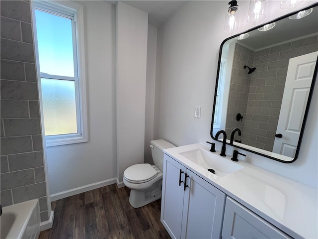 full bathroom featuring a healthy amount of sunlight, vanity, toilet, and wood-type flooring