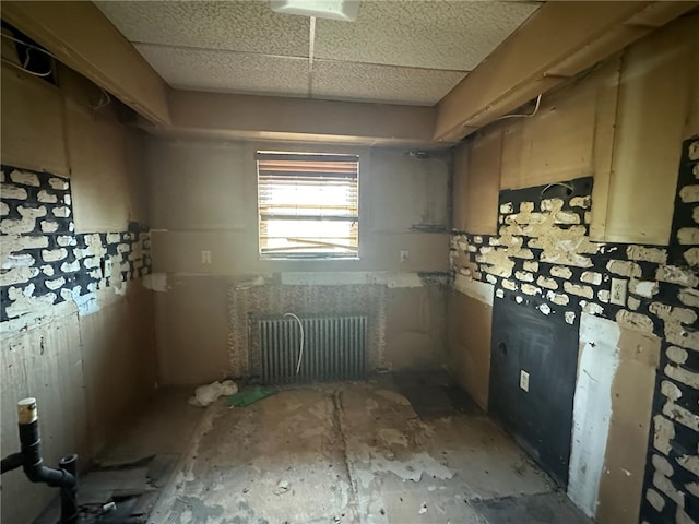 kitchen with radiator and a drop ceiling