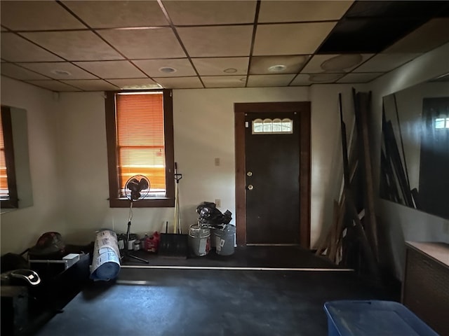 foyer entrance with concrete flooring and a drop ceiling