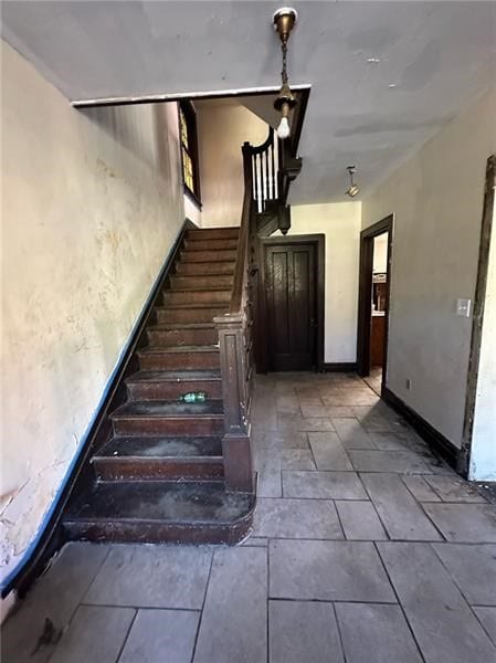 stairs with tile patterned floors