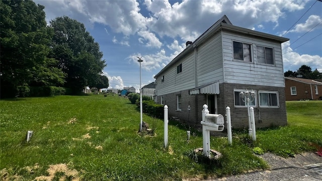 view of side of property with a yard