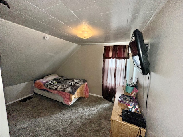 carpeted bedroom with vaulted ceiling