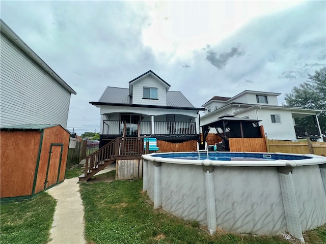 rear view of property featuring a storage shed