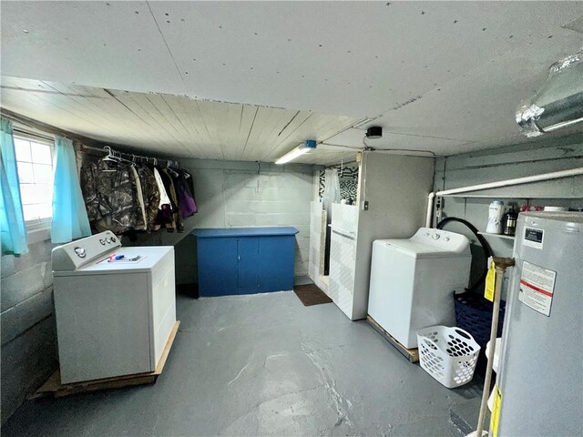 basement featuring water heater and washer / clothes dryer