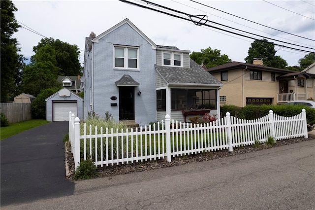 front facade with a garage and an outdoor structure