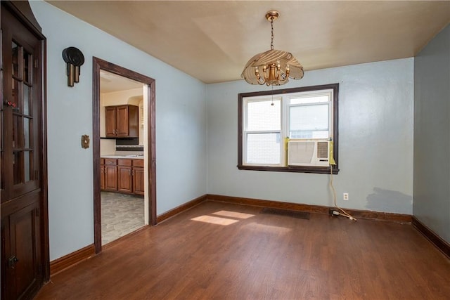 unfurnished room featuring cooling unit and dark hardwood / wood-style floors