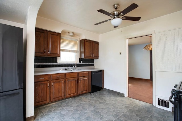 kitchen featuring tasteful backsplash, sink, ceiling fan, and black appliances