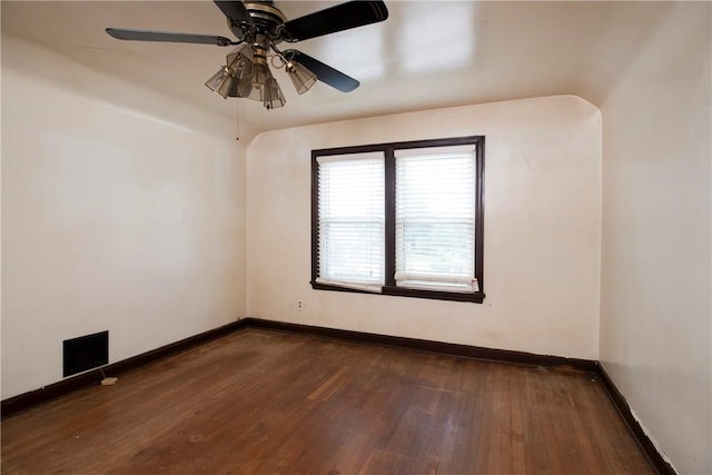 spare room featuring ceiling fan and dark hardwood / wood-style floors