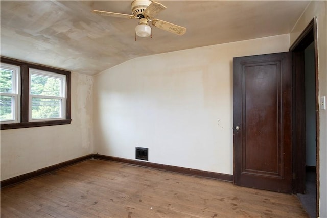 empty room featuring vaulted ceiling, ceiling fan, and light wood-type flooring