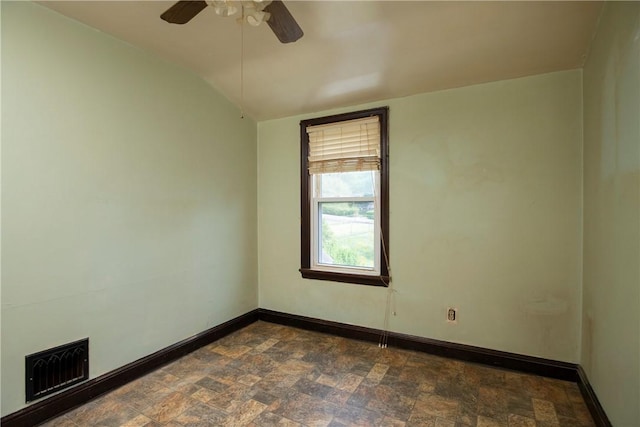 empty room featuring lofted ceiling and ceiling fan