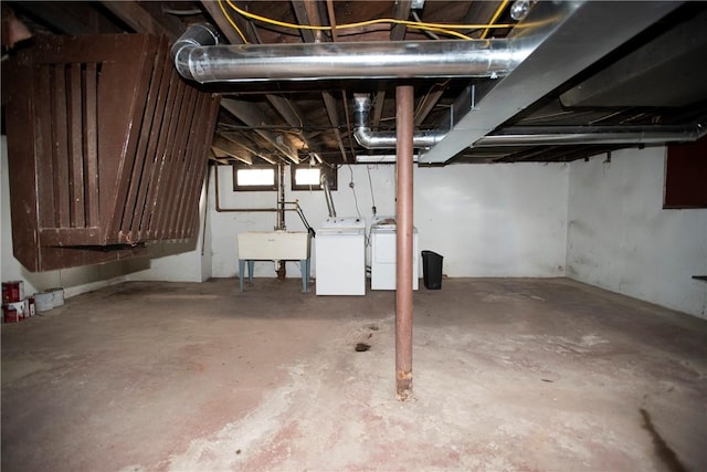 basement with sink and washer and clothes dryer