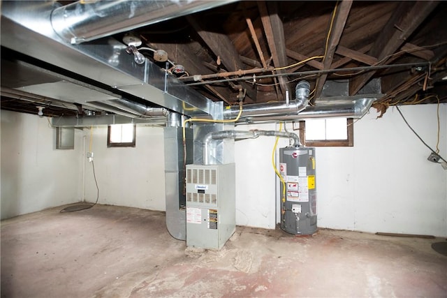 basement featuring heating unit and gas water heater