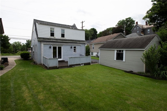 back of house featuring central air condition unit and a lawn