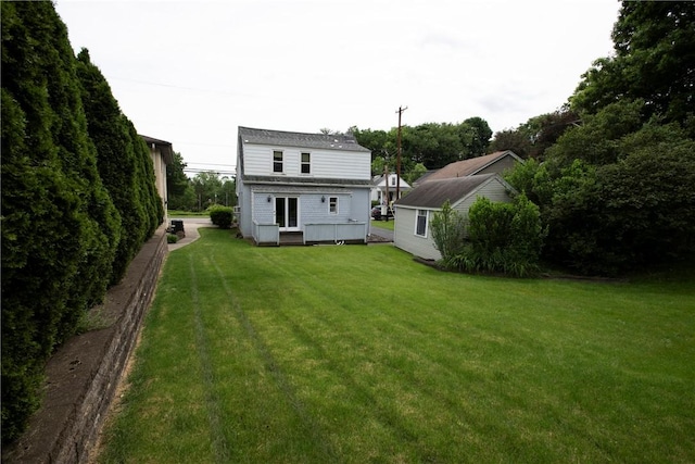 back of house with a lawn