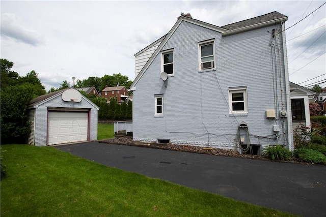 view of home's exterior with an outbuilding, a yard, and a garage