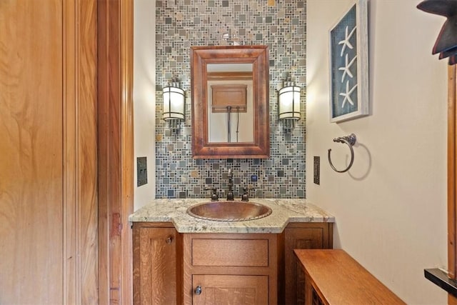 bathroom featuring tasteful backsplash and vanity