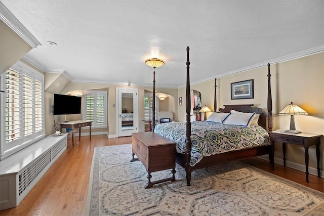 bedroom with ornamental molding and light wood-type flooring