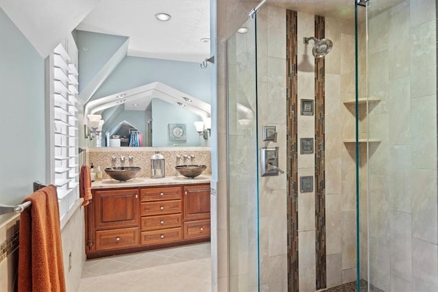 bathroom with tile patterned flooring, vanity, backsplash, and a shower with shower door