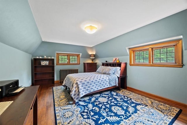 bedroom featuring dark wood-type flooring, radiator, and vaulted ceiling