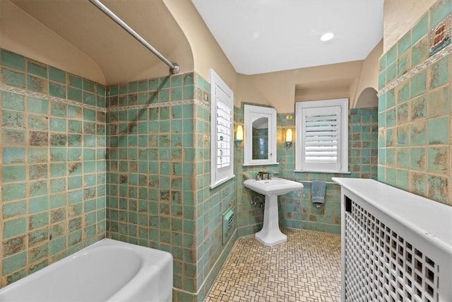 bathroom featuring tile walls, sink, tile patterned floors, and shower / bathtub combination