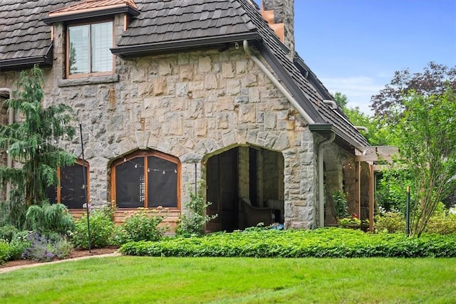 view of side of home featuring a lawn