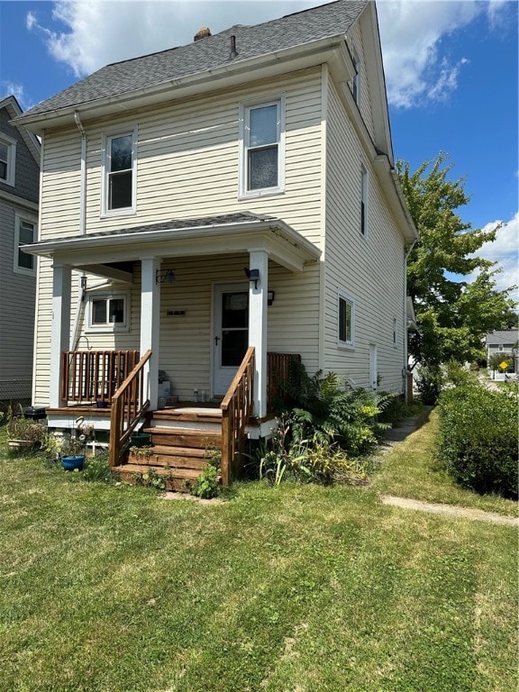 view of front facade with a front yard and a porch