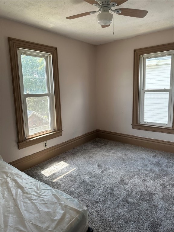 unfurnished bedroom featuring carpet flooring and ceiling fan