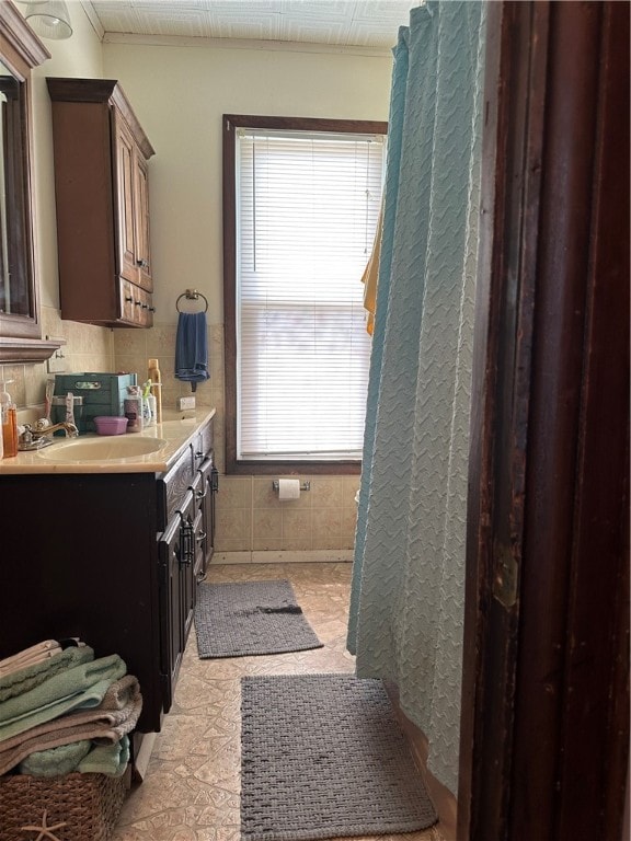 bathroom featuring plenty of natural light, vanity, tile floors, and crown molding