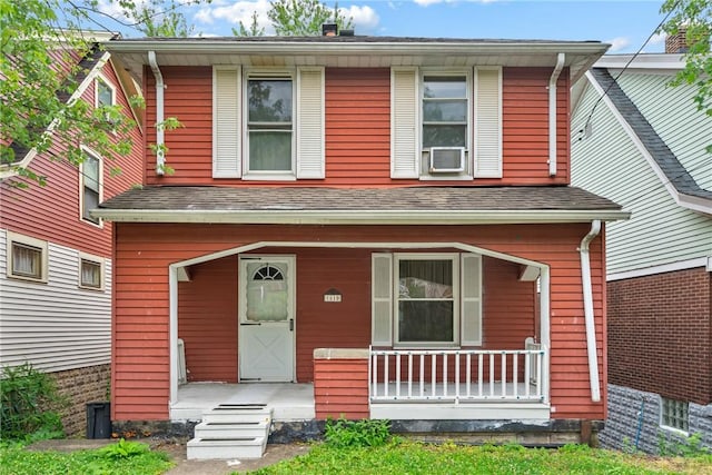 view of front of property with a porch and cooling unit