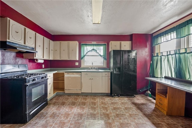 kitchen featuring a textured ceiling, sink, and black appliances