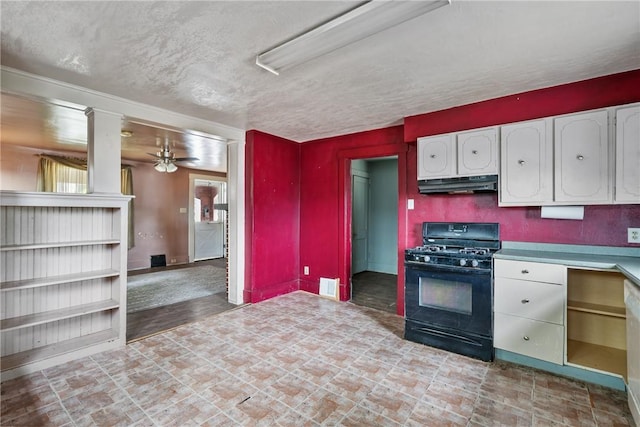 kitchen featuring ceiling fan, black gas stove, white cabinets, and a textured ceiling